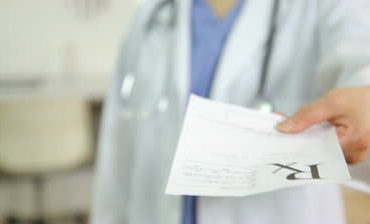 stock-footage-doctor-giving-a-prescription-close-up