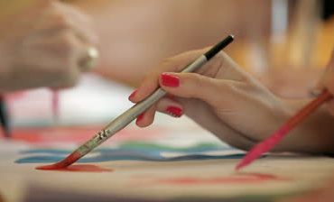 stock-footage-people-painting-an-image-with-watercolors-at-art-classes